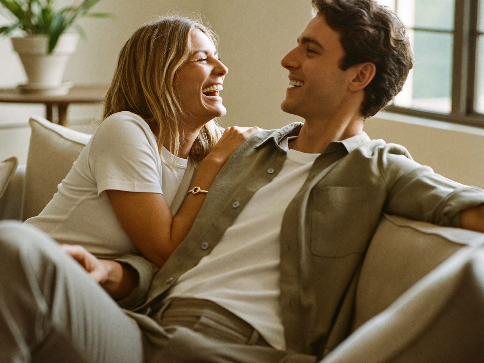 A happy engaged couple laughing together before their marriage